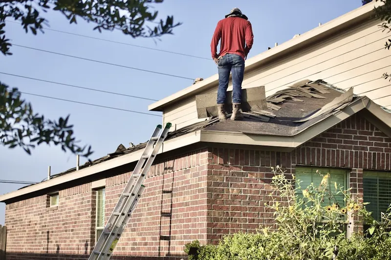 Professional roofer working on a residential roof in Evans Hill